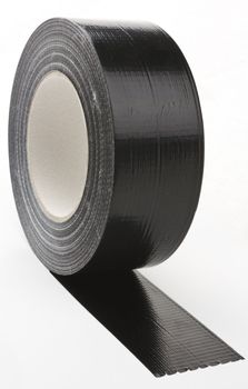 black adhesive tape  on light background. partly unroled