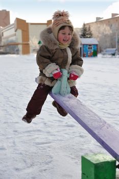 The girl on a swing. Winter, solar frosty weather