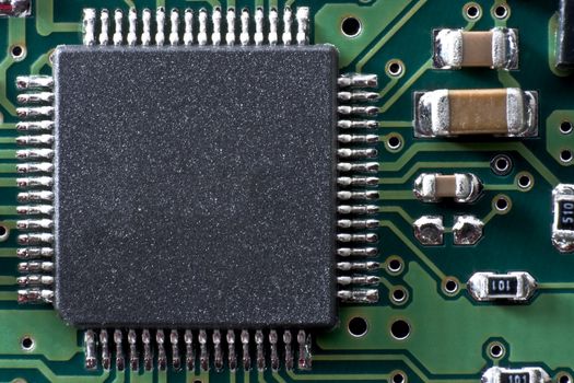 green circuit board with IC and other electronic components. Space for text on IC.