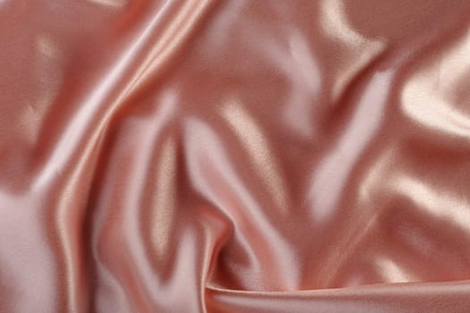 creamy satin background. A satiny fabric with beautiful light-shadow waves