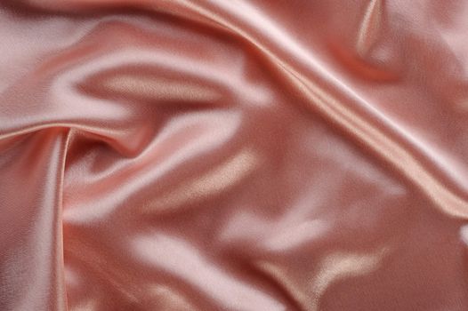 creamy satin background. A satiny fabric with beautiful light-shadow waves