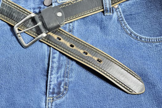 Jeans. A fragment trousers - jeans, with a leather belt