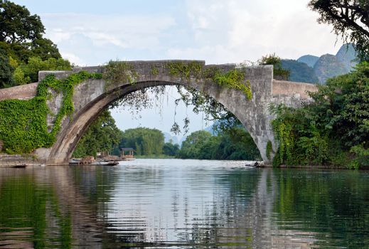 Chinese stone bridge landscape on li river with bridge reflection on water