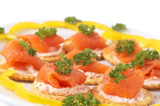 Smoked salmon and cream cheese on mini crackers with freshly cracked black pepper and garnishing of parsley