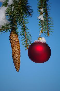 red bauble christmas ball ornament outside in a snowy winter scene