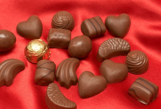 Assortment of Valentines chocolates on red silk