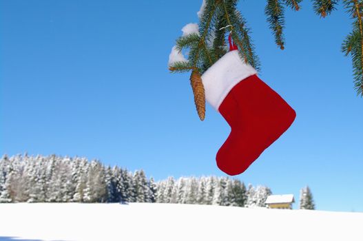 Santa Claus Christmas boot for gifts outside in a snowy landscape