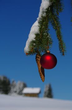 red bauble christmas ball ornament outside in a snowy winter scene