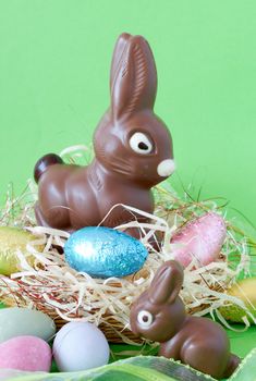 Assortment of chocolate Easter eggs wrapped in colorful paper with edible chocolate bunnies