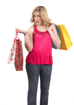 Portrait of a beautiful young blonde woman wearing a pink fashionable top and holding shopping bags over her shoulder. Isolated on white background