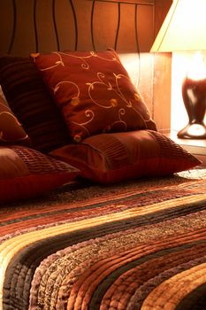 Colorful cushions on a bed in a guest lodge