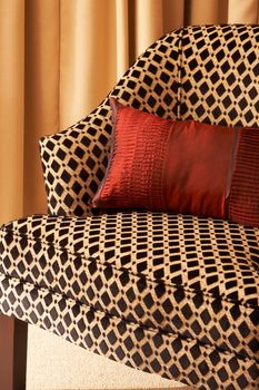 Colorful cushions on a chair in a guest lodge