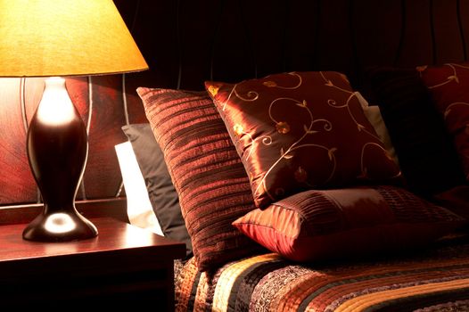 Colorful cushions on a bed in a guest lodge