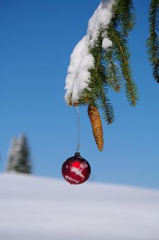 red bauble christmas ball ornament outside in a snowy winter scene