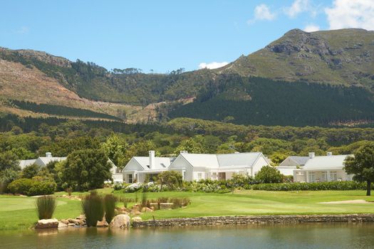 Golf course landscape with few houses in the mountains on a beautiful summer day