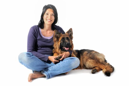portrait of a  purebred german shepherd and chinese girl in front of white background