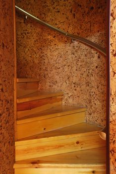 Wooden spiral staircase. An iron handrail, a steep slope