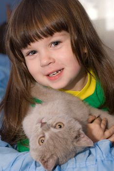 The little girl and cat. The three-year child of the European nationality