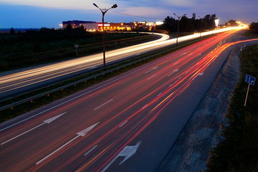 Light trails of evening highway. Urban background