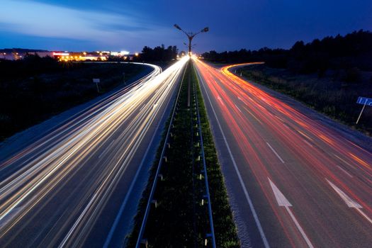 Light trails of evening highway. Urban background