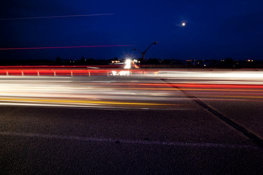 Light trails of evening highway. Urban background