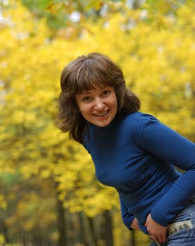 The girl on a background autumn forest. Age - 26 years