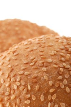 bun for sandwich. A bakery product strewed by grains