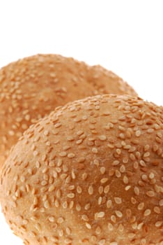 bun for sandwich. A bakery product strewed by grains