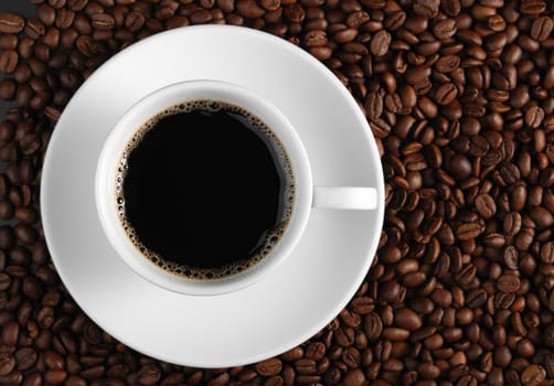 Cup of coffee. A background with coffee grains and a white cup. A photo close up 