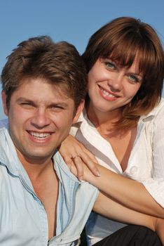 men and women. Happy family on a background of the blue sky