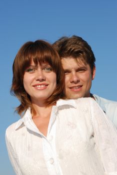 men and women. Happy family on a background of the blue sky