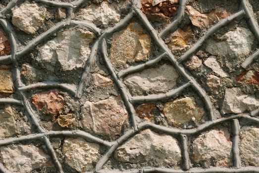Stone fence. A wall laid out in the abstract form from a wild stone