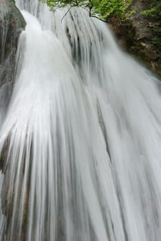 waterfall. A picturesque stream of falling water in mountains of the Crimean peninsula