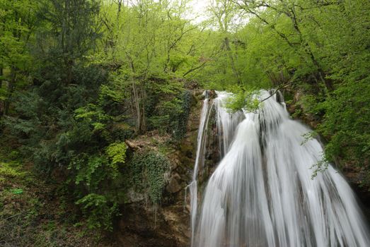 waterfall. A picturesque stream of falling water in mountains of the Crimean peninsula