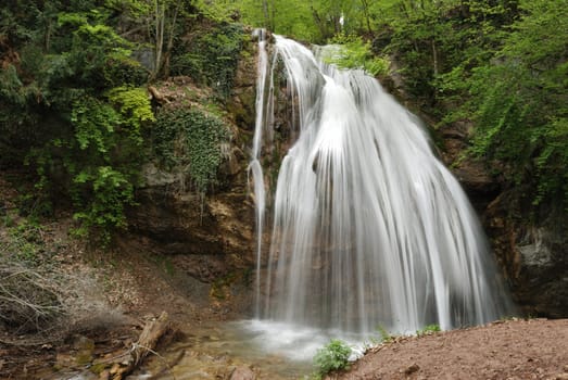 waterfall. A picturesque stream of falling water in mountains of the Crimean peninsula
