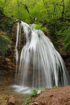 waterfall. A picturesque stream of falling water in mountains of the Crimean peninsula