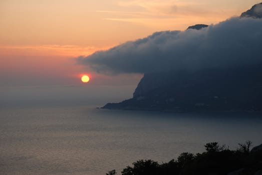 Sunset. A picturesque sunset with fantastic foggy under mountain