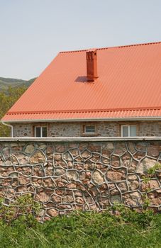 Red roof. A cottage constructed highly in mountains