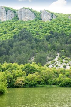 Mountains and  lake. Crimean mountains covered dense forest and lake foreground