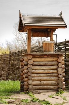 Well. An old well made of integral logs with a wooden bucket