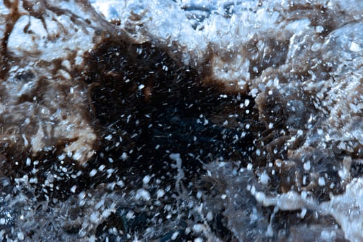 some rocks being washed over by the waves