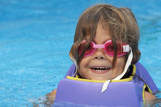 a young girl playing in pool