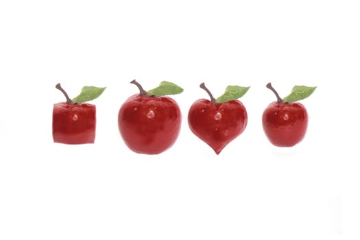 four red apples of various shapes on a white background with rain drops and love hearts with clipping path