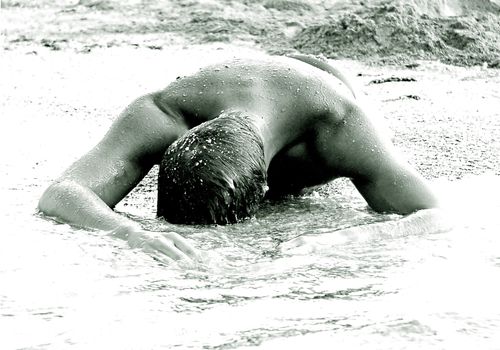 The man with a beautiful body in water 