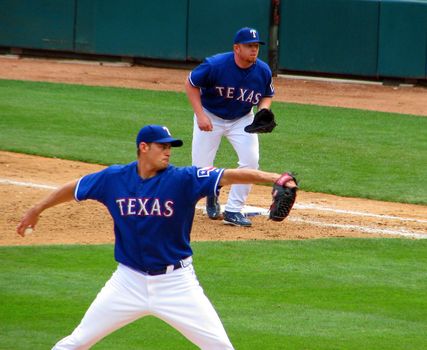 A Texas Rangers pitcher in the process of pitching to a Seattle Mariner batter in May, 2008 at Ranger Stadium in Arlington.
