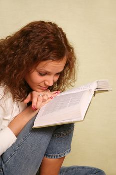 The young girl reads the book