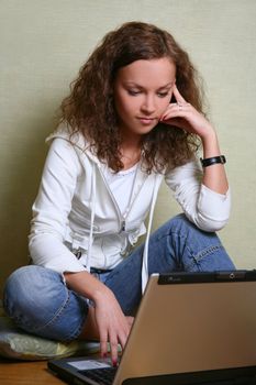Portrait of the young girl with a computer