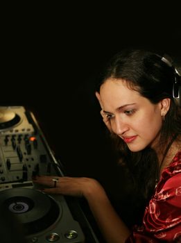 The girl in headphones in a night club 