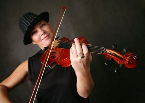  The woman in a hat, playing its violin with a smile