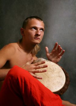 Man playing the nigerian drum in studio